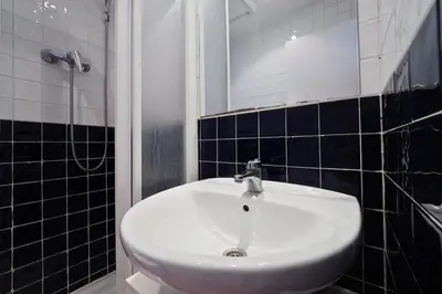 a bathroom with a white sink and a mirror at Sunny Apartments Barcelona in Barcelona