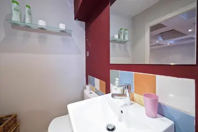 a bathroom with a white sink and a mirror at Sunny Apartments Barcelona in Barcelona