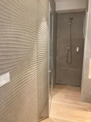 a shower with a glass door in a bathroom at APARTAMENTO 10 MIN SITGES in Puigmoltó