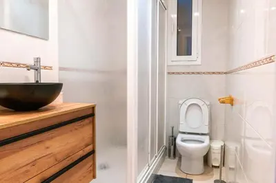 a bathroom with a toilet and a sink at Orange crush Barcelona in Barcelona