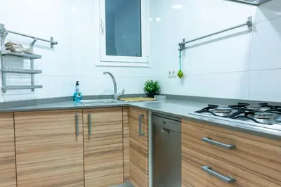 a kitchen with a sink and a stove at Orange crush Barcelona in Barcelona