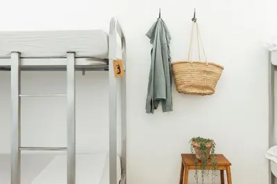a bedroom with a bunk bed and a basket on a wall at Casa Jam Barcelona in Barcelona