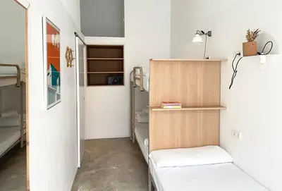 a small room with a bed and a shelf at Casa Jam Barcelona in Barcelona