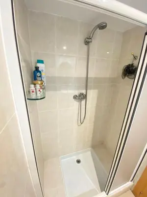 a shower in a bathroom with a glass door at Coast apartment near Barcelona in Sant Andreu de Llavaneres