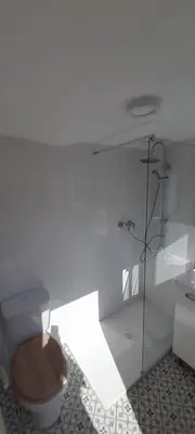 a bathroom with a toilet and a glass shower at Mediterranien Terrace in Calella