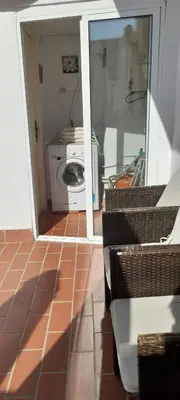 an open door to a bathroom with a washing machine at Mediterranien Terrace in Calella