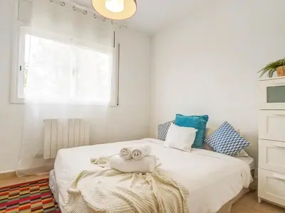 a bedroom with a bed with towels on it at Villa Papallona by Hello Homes Sitges in Sant Pere de Ribes