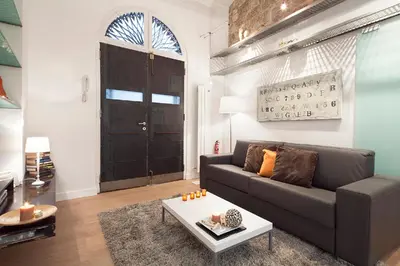 a living room with a couch and a table at Cathedral Apartment in Barcelona