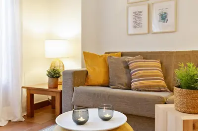 a living room with a couch and a table at Columbus Apartment in Barcelona