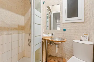 a bathroom with a sink and a toilet and a mirror at Bright 3BR2BA w Balcony in Eixample in Barcelona