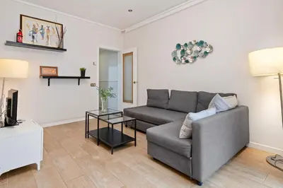 a living room with a couch and a table at Bright 3BR2BA w Balcony in Eixample in Barcelona