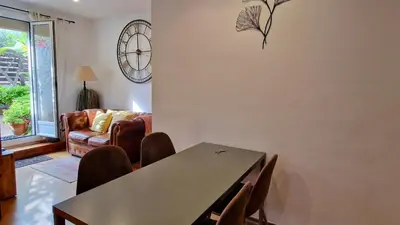 a living room with a table and chairs and a couch at Àtic Trobador in Barcelona