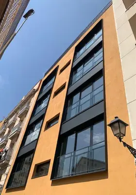 a tall building with windows and a street light at CATERINA Santa Mònica in Barcelona