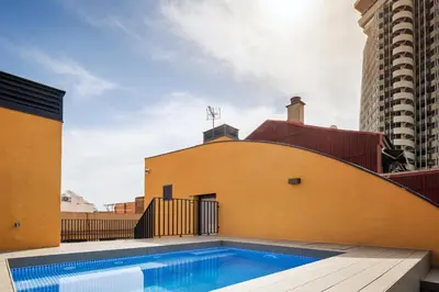 a swimming pool on the roof of a building at CATERINA Santa Mònica in Barcelona