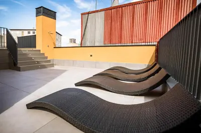 a group of benches on the side of a building at CATERINA Santa Mònica in Barcelona