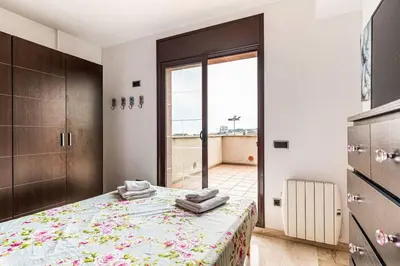 a bedroom with a bed and a large window at Casa rustica con piscina y jardin in Pineda de Mar