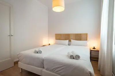 a bedroom with a white bed with two towels on it at Habitat Apartments Bailén in Barcelona