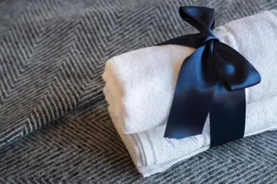 a tie sitting on top of a pile of towels at Habitat Apartments Bailén in Barcelona
