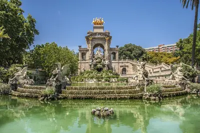 a building with a fountain in the middle of a body of water at Habitat Apartments Bailén in Barcelona