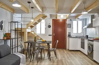 a kitchen and dining room with a table and chairs at BeBarceloner Eixample Duplex Apartments in Barcelona