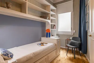 a small bedroom with a bed and a desk at Balmes Apartment by Olala Homes in Barcelona