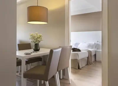 a room with a table and chairs and a bed at Rambla 102 in Barcelona