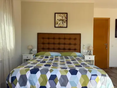 a bedroom with a large bed and two night stands at Olivella Bed&breakfast in Olivella