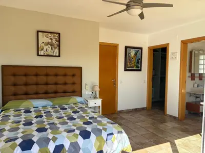 a bedroom with a bed and a ceiling fan at Olivella Bed&breakfast in Olivella