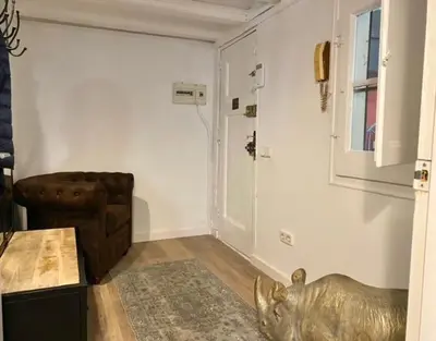 a living room with a dog statue in a room at New design apartment in Barcelona center. in Barcelona
