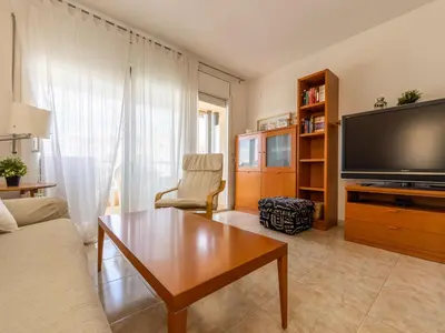 a living room with a large flat screen tv at Apartment Girona by Interhome in Cubelles
