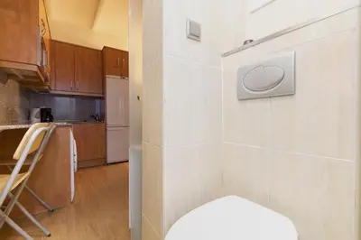 a small kitchen with a counter and a stove at ApartEasy - Central Barcelona Studio Apartment in Barcelona