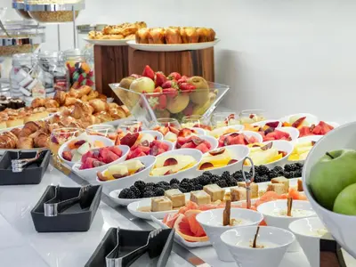 a buffet of fruit and pastries on a table at H10 Art Gallery 4* Sup in Barcelona