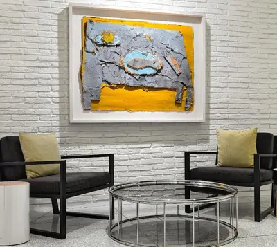 a room with two chairs and a table and a painting at H10 Art Gallery 4* Sup in Barcelona