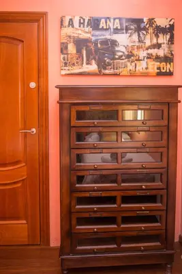 a wooden chest of drawers in a room at Splendid Gaudi Mercat del Ninot Apartment in Barcelona