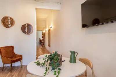 a dining room with a white table and chairs at Aragó Suites in Barcelona