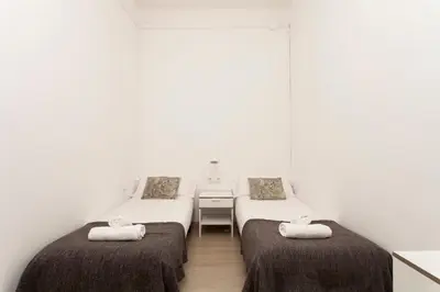 a room with two beds with towels on them at 1554 - AB Passeig de Gràcia Pelai in Barcelona