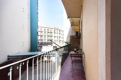 a balcony with chairs and a table on a building at 1554 - AB Passeig de Gràcia Pelai in Barcelona