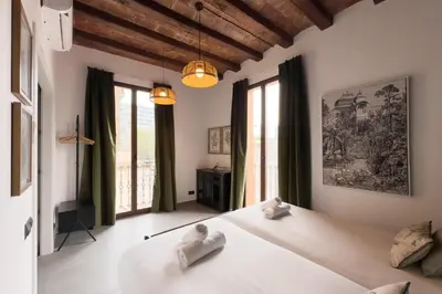 a bedroom with a large white bed and windows at Bebarceloner Poble Nou Apartments - 1 bedroom in Barcelona