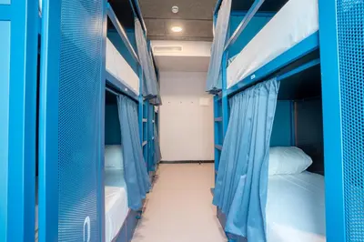 a row of bunk beds in a hostel at Malacuna Barcelona in Barcelona