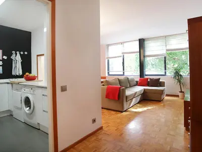 a living room with a couch and a washing machine at Apartment Vila Olimpica Pamplona by Interhome in Barcelona