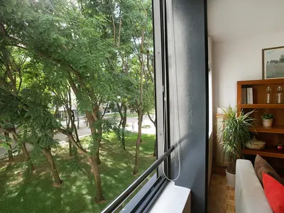 a window in a room with a view of trees at Apartment Vila Olimpica Pamplona by Interhome in Barcelona