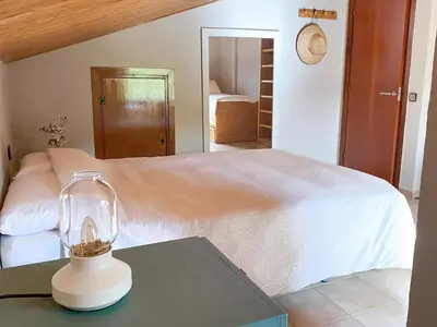 a bedroom with a bed and a table with a lamp at Casa Magnolia in Dosríus