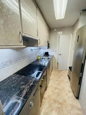 a kitchen with a sink and a refrigerator at Beach Apartment Barca 6 in Sant Adria de Besos