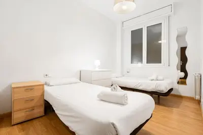 a bedroom with two beds and a window at Sunny Terrace Retreat AC 3BR2BA in Barcelona