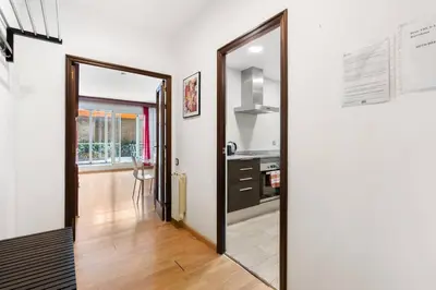 an open door to a kitchen with a mirror at Sunny Terrace Retreat AC 3BR2BA in Barcelona
