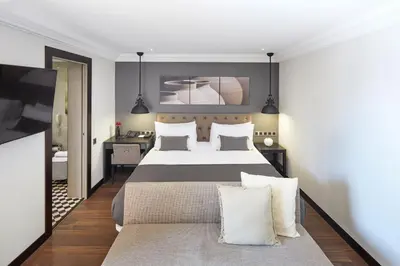 a bedroom with a large bed and a television at Hotel Cortes Rambla in Barcelona