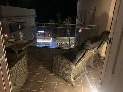 a balcony with two wicker chairs and a table at Cunit, front line with sea view in Cunit