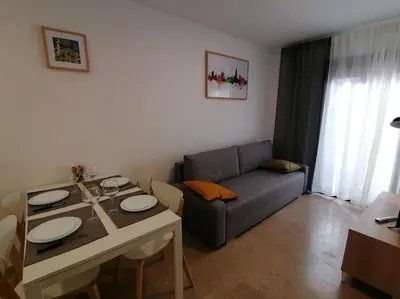 a living room with a table and a couch at Piso pl 2B, 20min Plaza Cataluña in Sant Adria de Besos