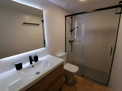 a bathroom with a sink and a toilet and a mirror at Piso pl 2B, 20min Plaza Cataluña in Sant Adria de Besos