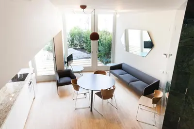 a living room with a couch and a table at Aspasios City Oasis Apartments in Barcelona